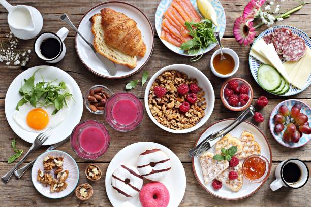 Brunch. Family breakfast or brunch set served on rustic wooden table. Overhead view, copy space